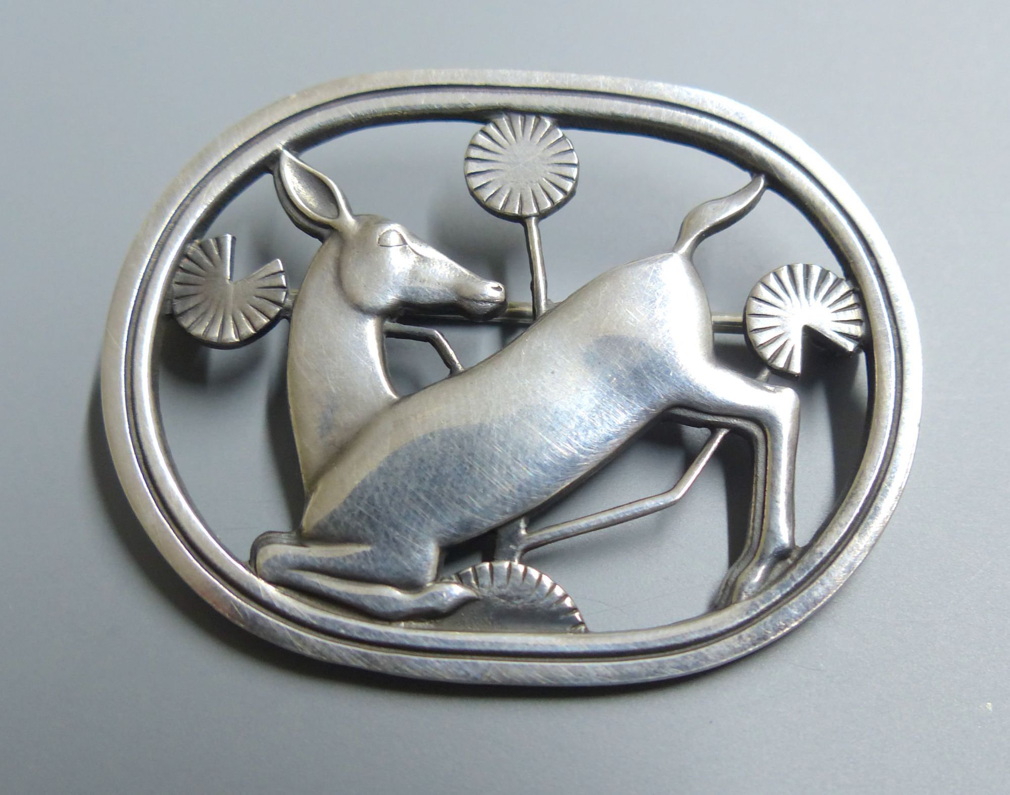 A Georg Jensen sterling kneeling deer oval brooch, designed by Arno Malinowski, no. 256, 43mm.